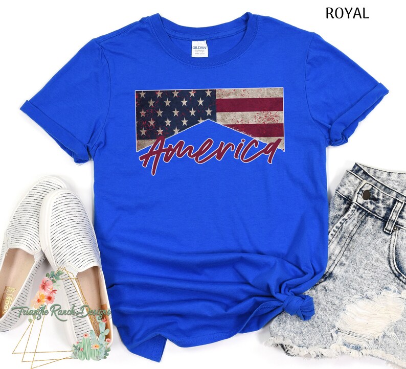 May include: A royal blue t-shirt with a distressed American flag design and the word "America" in red lettering.