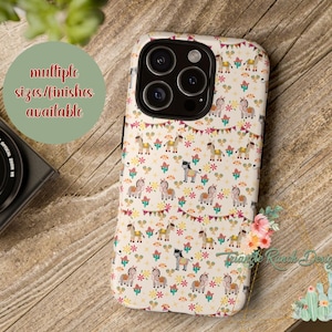 May include: A phone case featuring a repeating pattern of cartoon horses, cacti, and floral elements on a cream background. The case has a multi-camera lens cutout. Text on the case reads "multiple sizes/finishes available".