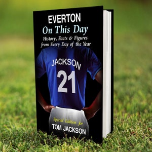 May include: A black book cover with the title "EVERTON On This Day" and the text "History, Facts & Figures from Every Day of the Year". The cover features a blue football shirt with the name "JACKSON" and the number "21" on the back. The text "Special Edition for TOM JACKSON" is at the bottom of the cover.