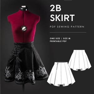 Pode incluir: Uma saia preta com bordado decorativo branco num manequim vermelho. O texto diz: NEKO PATTERNS, 2B SKIRT, PDF SEWING PATTERN, ONE SIZE | SIZE M, PRINTABLE PDF. Inclui um desenho linear branco da frente e das costas da saia com fecho lateral.