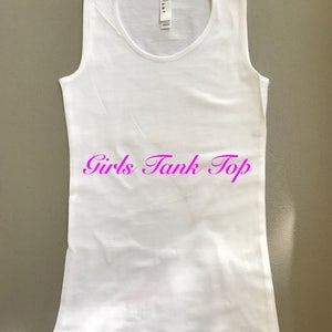 May include: White sleeveless tank top with the text "Girls Tank Top" printed in pink.