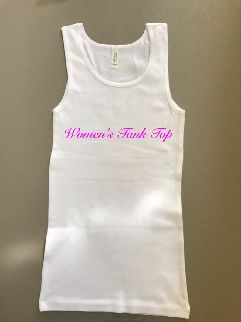 May include: White tank top with the text "Women's Tank Top" in pink lettering.