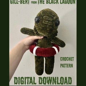 May include: A crochet pattern for a green creature from the Black Lagoon, holding a red and white life preserver. The pattern is a digital download. The text "Gill-Bert from The Black Lagoon" and "Crochet Pattern" are visible in the image.