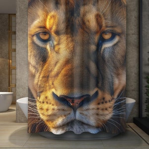 May include: Close-up of a lion's face. The lion has a golden brown coat with black stripes and a dark brown nose. The lion's eyes are open and looking directly at the viewer.
