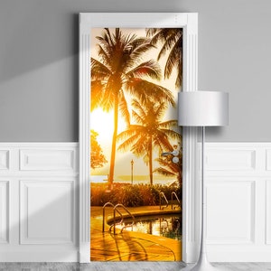 May include: A door decal featuring a tropical scene with palm trees, a pool, and a sunset. The decal is printed on a white background and is perfect for adding a touch of paradise to any room.