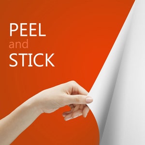 May include: A hand is peeling back a corner of a white sheet of paper, revealing a bright orange background with the text "PEEL and STICK" in white.