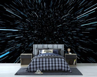 May include: A black and white checkered bedspread on a bed with a headboard against a black background with blue streaks of light radiating from the center.