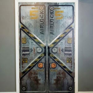 May include: Double doors with a distressed metal effect, displaying the text "AIRLOCK 5" in yellow. The doors feature caution and warning labels, with black and yellow diagonal stripes. The design evokes an industrial or science fiction aesthetic.