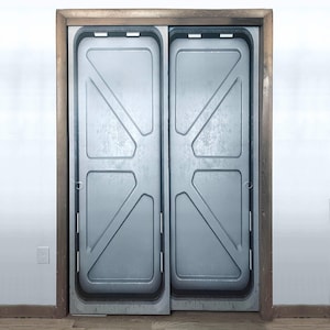 May include: Sliding doors with a metallic, industrial design. The doors are light grey with a textured surface and geometric patterns. They are framed by a wooden border.