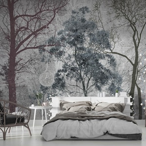 May include: A gray and white bedroom with a bed with gray bedding and a white headboard. The wall behind the bed has a mural of trees in shades of gray and white.