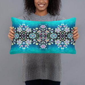 May include: A turquoise blue throw pillow with a colorful mandala design. The mandala features a black background with colorful flowers and leaves.