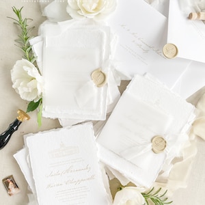May include: White wedding invitation suite with gold calligraphy and wax seals. The invitation features the names Sasha Hernandez and Warren Chiapparelli. The RSVP card says "Kindly RSVP by July 1st, 2023".