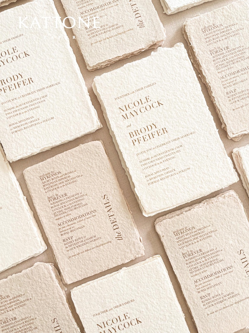 Fine art wedding invitation suite including handmade deckle edge invitation, RSVP cards, details cards and silk ribbon styling arranged in editorial flat lay.
