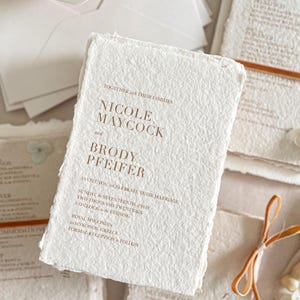 Luxury romantic wedding stationery suite with colored handmade cotton paper invitations, terracotta typography and elegant minimalist design.