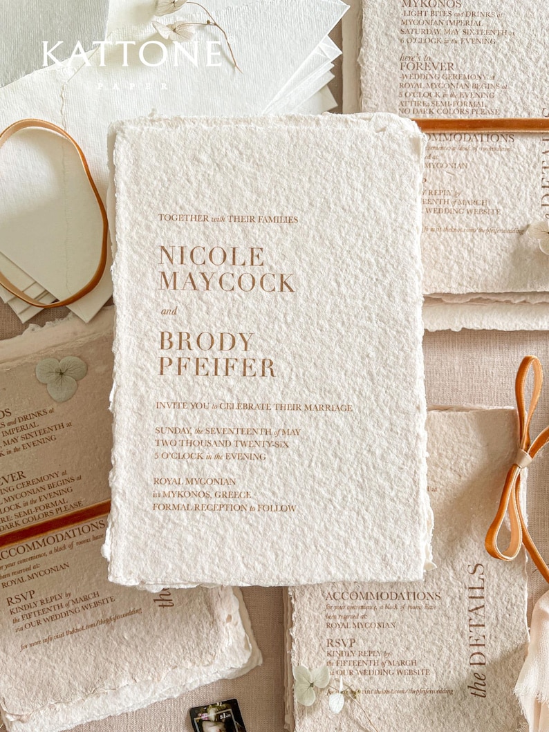 Handmade cotton paper wedding invitation with organic deckle edges featuring warm terracotta typography printed on textured ivory handmade paper for luxury fine art wedding stationery.