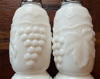 Vintage Milk Glass grape grapevine design salt and pepper shakers with silver-coated lids. Very good vintage condition.