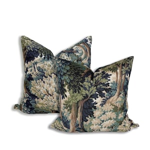 a pair of blue and green pillows on a white background