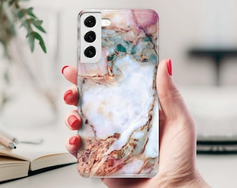 May include: A white phone case with a marble pattern in shades of pink, brown, and green. The case has a raised camera bump with three lenses.