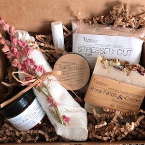 Mother's Day Rose spa gift set includes your choice of salts, a rose petals and cream facial soap, rosebud balm with rosehip oil and shea butter, a mango lip balm, rose clay and microfiber washcloth with a sprig of pink flowers.