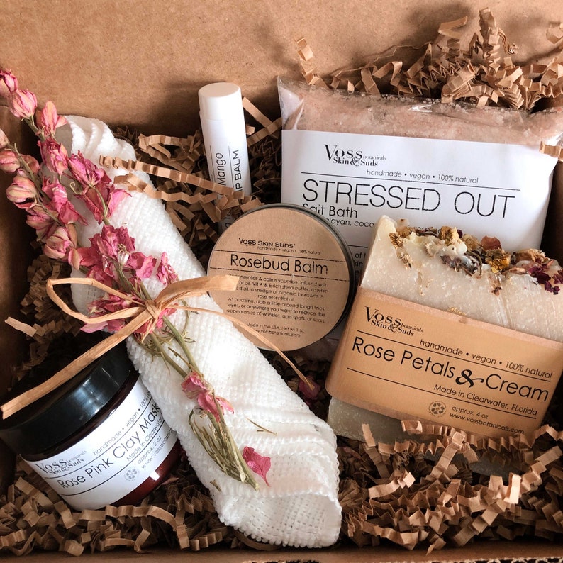 Mother's Day Rose spa gift set includes your choice of salts, a rose petals and cream facial soap, rosebud balm with rosehip oil and shea butter, a mango lip balm, rose clay and microfiber washcloth with a sprig of pink flowers.