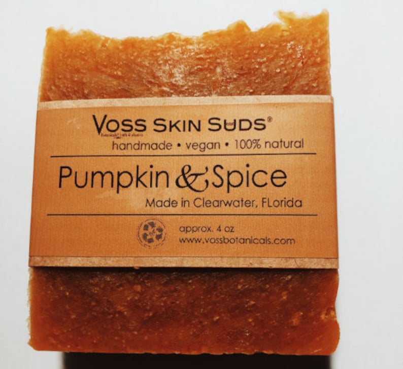 May include: A bar of brown soap with a label that reads "VOSS SKIN SUDS handmade vegan 100% natural Pumpkin & Spice Made in Clearwater, Florida approx. 4 oz www.vossbotanicals.com"