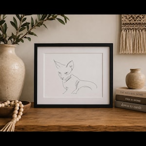 K&ouml;nnte beinhalten: Ein schwarzer rechteckiger Rahmen mit einem wei&szlig;en Druck, der eine minimalistische schwarze Strichzeichnung einer Sphynx-Katze zeigt. Die Katze ist in sitzender Position mit spitzen Ohren und einem schlanken K&ouml;rper mittig im Rahmen dargestellt.