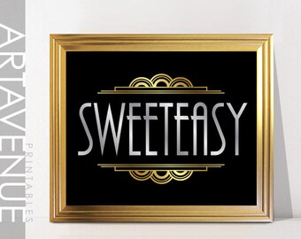 May include: A framed art print with a black background and gold frame. The print features the word "SWEETEASY" in silver, with gold art deco style accents above and below the text. The words "ARTAVENUE PRINTABLES" are printed vertically on the left side.
