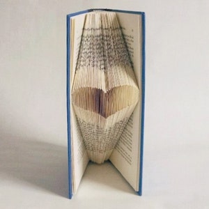 May include: A blue hardback book with the pages folded into a heart shape.