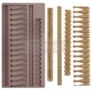 May include: A silicone mold for making decorative cake borders and tassels. The mold is brown and features five different designs, including a rope-like braid, a wavy pattern, a tassel design, and two different types of fringe. The mold is labeled "TASSEL FRINGE" and "Fredesigns".