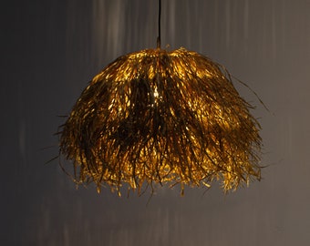 May include: A hanging light fixture with a round, woven shade made of natural fibers. The shade is lit from within, casting a warm glow.