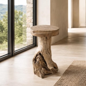 May include: A rustic, wooden side table with a round top and a natural, textured base. The table is made from a tree trunk, showcasing the wood's grain and knots. The table is approximately 20 inches tall.