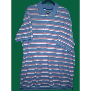 May include: A short-sleeved polo shirt with horizontal stripes in blue, white, and coral. The shirt has a collared neckline and a three-button placket. The shirt is hanging on a black hanger against a green background.