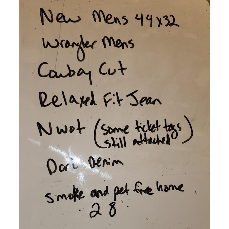 May include: Whiteboard with handwritten text: "New Mens 44x32 Wrangler Mens Cowboy Cut Relaxed Fit Jean Nwot (some ticket tags still attached) Dark Denim smoke and pet free home 28."