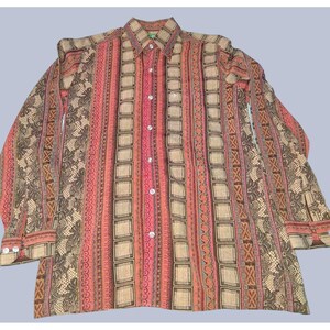 May include: A long-sleeved button-down shirt with a colorful, patterned design. The shirt features vertical stripes in shades of red, tan, and brown, with decorative square and floral patterns. It has a classic collar and buttoned cuffs.