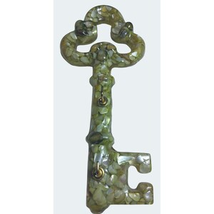 May include: Decorative key with a unique design. The key is covered in small, iridescent, light green and tan pieces. It has a classic key shape with a looped top and a detailed handle. Small brass-colored accents are visible.