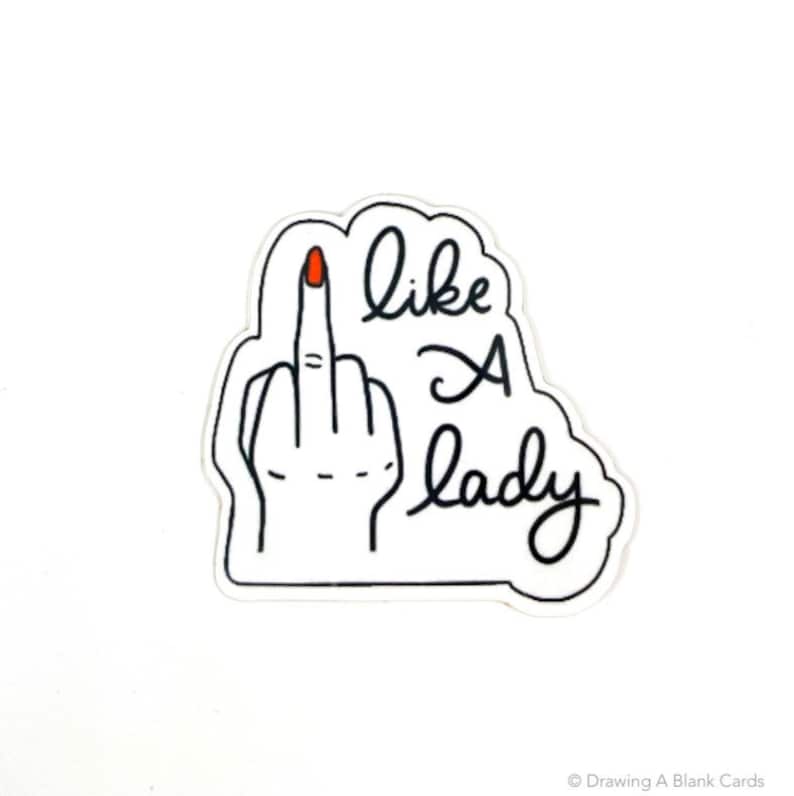 May include: Black and white sticker with a hand giving the middle finger and the text "like a lady".