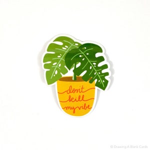 May include: A yellow pot with a green monstera plant inside. The pot has the text "don't kill my vibe" written on it in red.