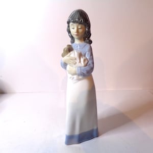 NAO by Lladro Young Girl cuddling her poorly puppy