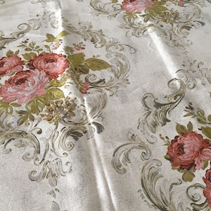 May include: White fabric with a floral pattern featuring pink and red roses, green leaves, and gold accents. The fabric has a damask-like design.