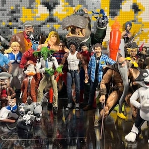 May include: A collection of action figures, featuring a diverse array of characters. The figures vary in size and design, with a mix of superheroes, cartoon characters, and other fictional figures. The figures are arranged closely together.