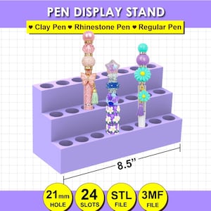 May include: A light purple three-tiered pen display stand with 24 slots, each 21mm in diameter. The stand is 8.5 inches wide and holds three decorative pens. Text on the image reads: PEN DISPLAY STAND, Clay Pen, Rhinestone Pen, Regular Pen.