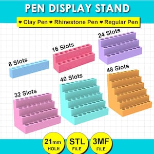 May include: A collection of tiered pen display stands in various colors including light blue, pink, purple, and orange. The stands feature 8, 16, 24, 32, 40, and 48 slots. Text includes PEN DISPLAY STAND, Clay Pen, Rhinestone Pen, Regular Pen, and 21mm HOLE.