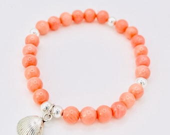 Beaded coral bracelet with silver scallop shell.