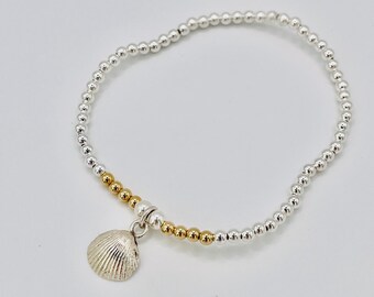Beaded bracelet with small silver shell.