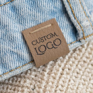 Customized faux leather clothing tags - Machine washable - We can use any of your designs.