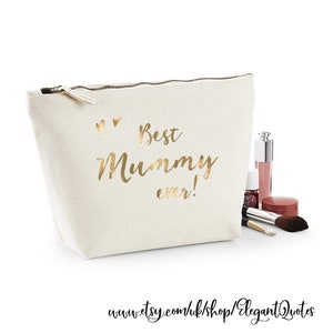 May include: A white canvas makeup bag with a gold zipper and the text "Best Mummy ever!" in gold lettering. Two small gold hearts are above the text.