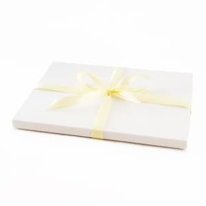 May include: A white gift box with a yellow ribbon tied in a bow.