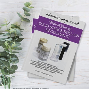 May include: Purple and white book cover with the title "Make It Yourself Solid Stick & Roll-On Deodorants". The cover features a photo of three deodorant sticks, two white and one black.