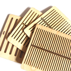 May include: Four wooden loom boards with rows of evenly spaced holes for weaving yarn. The boards are made of light brown wood and have a natural finish.