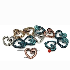 May include: A collection of heart-shaped beads with a horse head design. The beads are in various metallic finishes, including silver, gold, bronze, and teal. A small red bead is also present. These beads are suitable for jewelry making and crafts.